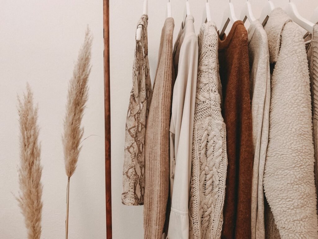 Neutral capsule pieces on a clothes rack illustrating modern chic style